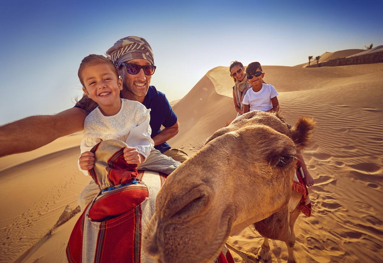 father and daughter camel ride