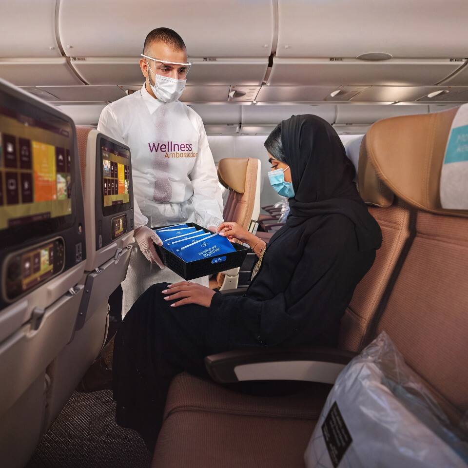 etihad staff serving a passanger